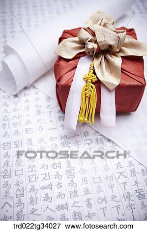 Stock Photo - traditional paper and a package wrapped in a traditional wrap . Fotosearch
