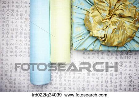 traditional papers next to a package wrapped in a traditional wrap with nice big ribbon View Large Photo Image Stock Photo - traditional papers next to a package wrapped in a traditional wrap with nice big ribbon . Fotosearch