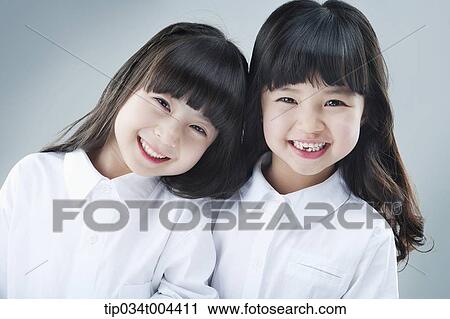 Stock Image - two female kids smiling together. Fotosearch