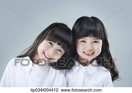 Stock Image - two female kids smiling together. Fotosearch