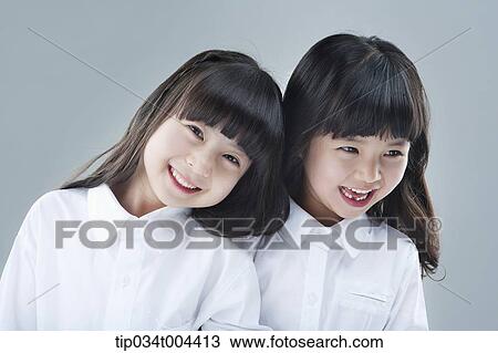Stock Image - two female kids smiling together. Fotosearch