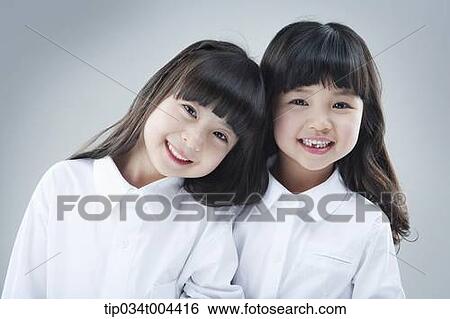 Stock Photograph - two female kids smiling together. Fotosearch