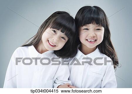 two female kids smiling together with arm in arm View Large Photo Image Stock Photography - two female kids smiling together with arm in arm . Fotosearch