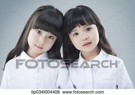 Stock Photo - two female kids standing together. Fotosearch