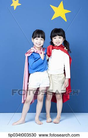 two girls with superman capes smiling in blue background with stars View Large Photo Image Stock Image - two girls with superman capes smiling in blue background with stars. Fotosearch