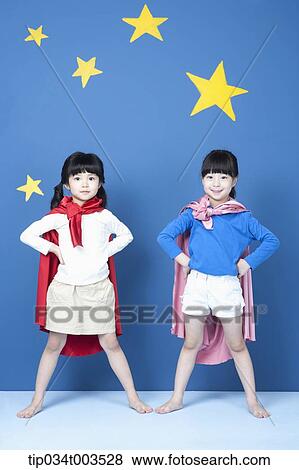 two girls with superman capes standing like a superman View Large Photo Image Stock Photo - two girls with superman capes standing like a superman. Fotosearch