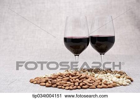two glasses of red wine and nuts on the floor View Large Photo Image Stock Image - two glasses of red wine and nuts on the floor . Fotosearch