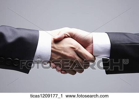 Stock Image - two hands held tightly each other . Fotosearch