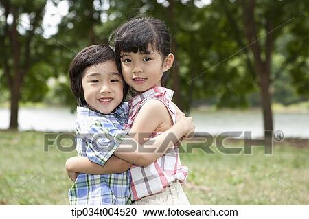 two kids hugging each other View Large Photo Image Stock Image - two kids hugging each other. Fotosearch