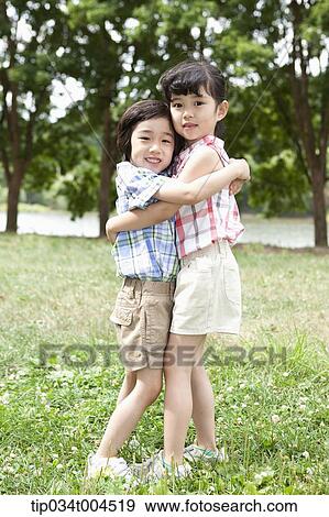 two kids hugging each other View Large Photo Image Stock Photo - two kids hugging each other. Fotosearch