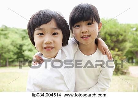 Picture - two kids posing with arms around each other. Fotosearch