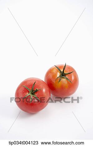 Stock Image - two tomatoes in white background . Fotosearch