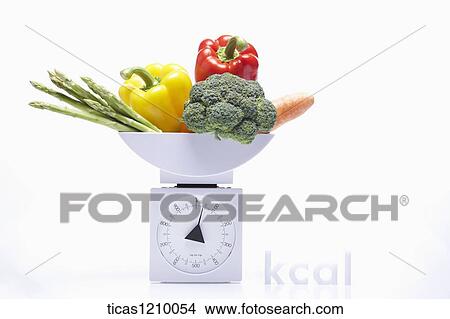 vegetables on a measuring scale View Large Photo Image Picture - vegetables on a measuring scale. Fotosearch