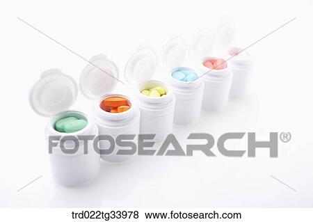 Stock Photo - white drug bottles filled up with different colours of medicine tablets . Fotosearch