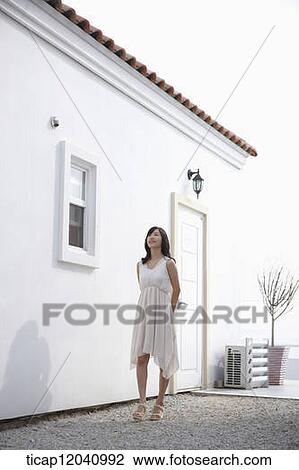 woman wearing white dress and walking by the house View Large Photo Image Stock Image - woman wearing white dress and walking by the house. Fotosearch