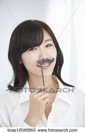 woman wearing white shirt and holding a mustache figure View Large Photo Image Stock Image - woman wearing white shirt and holding a mustache figure. Fotosearch