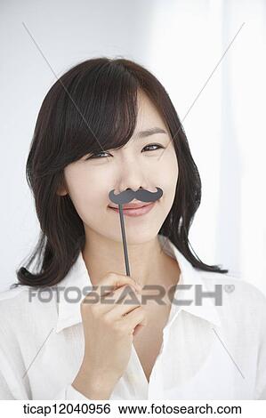 woman wearing white shirt and holding a mustache figure View Large Photo Image Stock Photograph - woman wearing white shirt and holding a mustache figure. Fotosearch