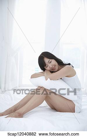 woman wearing white sleepwear and sitting on the bed View Large Photo Image Stock Image - woman wearing white sleepwear and sitting on the bed . Fotosearch