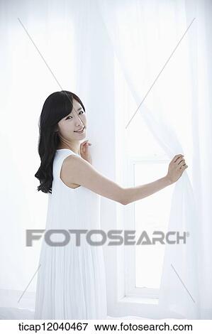 woman wearing white sleepwear and holding white curtain on the bed View Large Photo Image Stock Photo - woman wearing white sleepwear and holding white curtain on the bed. Fotosearch