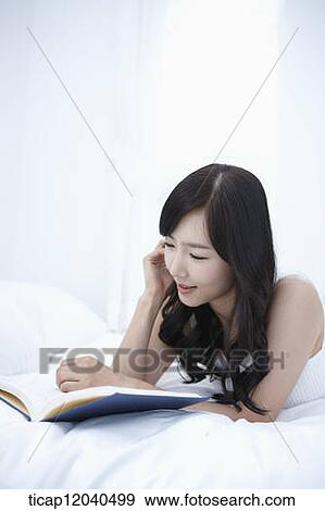 woman wearing white sleepwear and reading a book View Large Photo Image Stock Photo - woman wearing white sleepwear and reading a book . Fotosearch