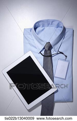 a blue shirt with a card holder and a tablet View Large Illustration Stock Illustration - a blue shirt with a card holder and a tablet. Fotosearch