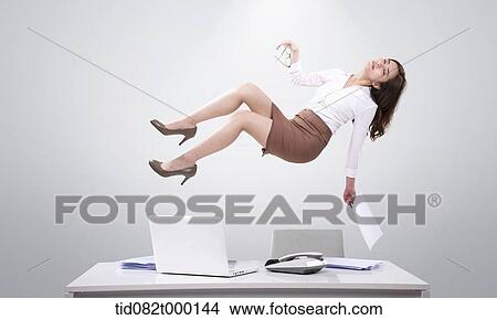 Stock Illustration - a business woman floating on top of her working desk. Fotosearch