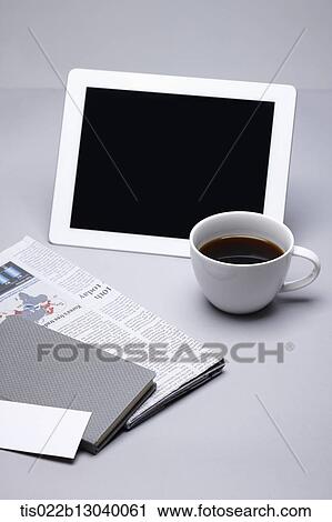a coffee cup, a tablet and a newspapers View Large Illustration Clip Art - a coffee cup, a tablet and a newspapers. Fotosearch
