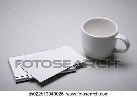 Stock Illustration - a coffee cup and papers. Fotosearch