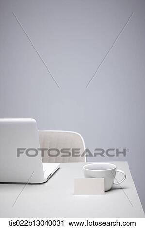 Clip Art - a coffee cup next to a laptop. Fotosearch