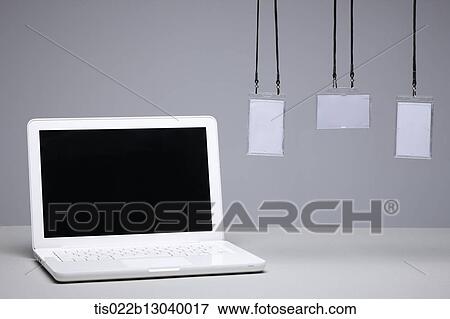 Stock Illustration - a laptop next to card holders. Fotosearch