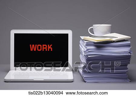 Stock Illustration - a laptop saying work next to a pile of papers. Fotosearch