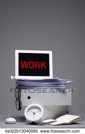 Stock Illustration - a laptop saying work on a pile of papers. Fotosearch