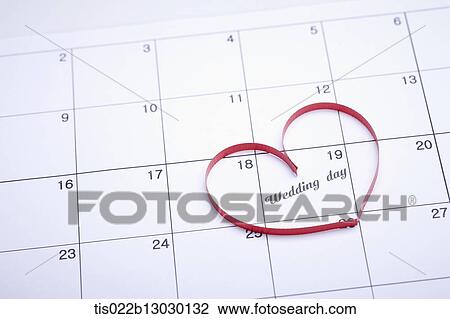 Drawing - a red ribbon in a heart shape on a calendar. Fotosearch