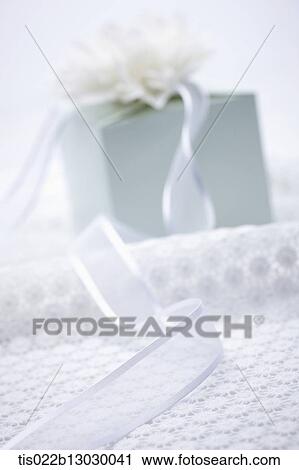 a white present with a flower View Large Illustration Clip Art - a white present with a flower. Fotosearch
