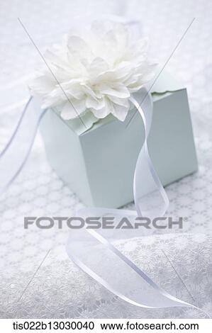 a white present with a flower View Large Illustration Clipart - a white present with a flower. Fotosearch