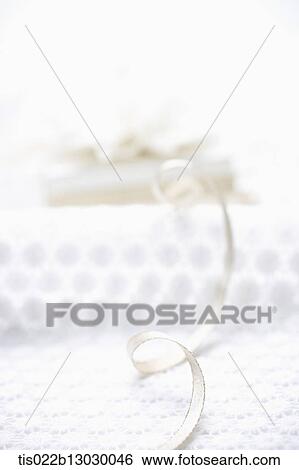 Stock Illustration - a white present with a flower. Fotosearch