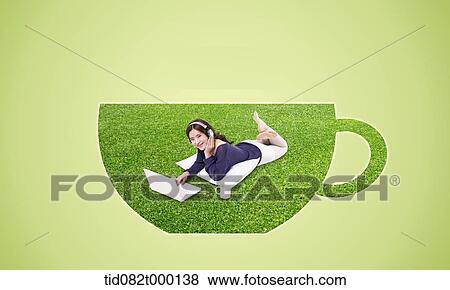 Stock Illustration - a woman lying on grass shaped like a coffee mug. Fotosearch