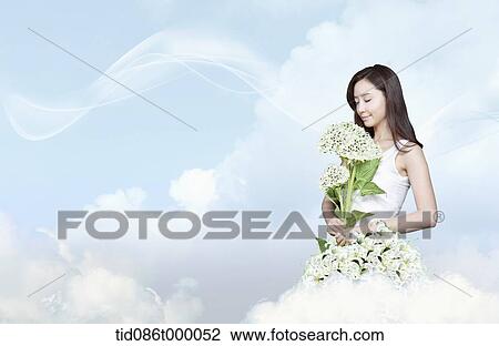 Drawing - a woman with flowers standing on a cloud. Fotosearch