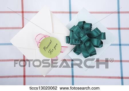 gift box with green ribbon and a card View Large Illustration Drawing - gift box with green ribbon and a card. Fotosearch