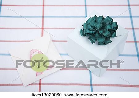 Clipart - gift box with green ribbon. Fotosearch