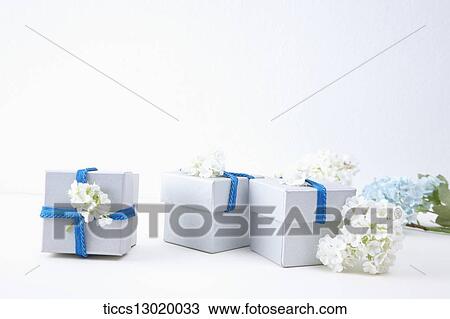 gift boxes with blue ribbons and flowers View Large Illustration Drawing - gift boxes with blue ribbons and flowers. Fotosearch