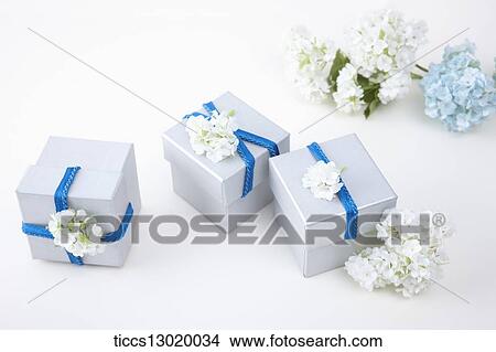 gift boxes with blue ribbons and flowers View Large Illustration Stock Illustration - gift boxes with blue ribbons and flowers. Fotosearch