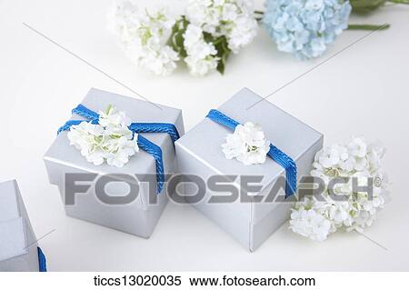 Stock Illustration - gift boxes with blue ribbons and flowers. Fotosearch