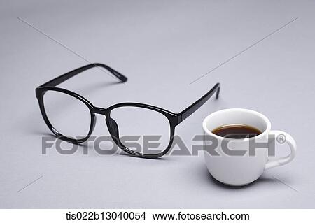 Stock Illustration - glasses next to a coffee cup. Fotosearch
