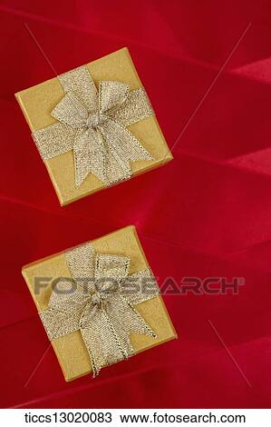 Drawing - graceful orange gift boxes with golden ribbons. Fotosearch