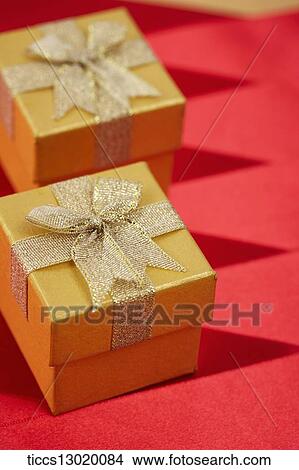 graceful orange gift boxes with golden ribbons View Large Illustration Stock Illustration - graceful orange gift boxes with golden ribbons. Fotosearch