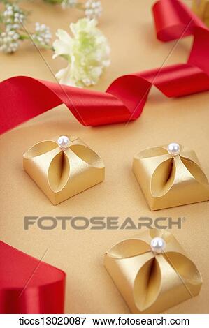 Stock Illustration - graceful orange gift boxes with pearls. Fotosearch