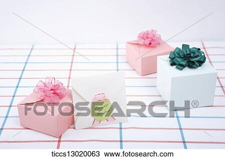 Drawing - pink and green ribbon gifts with a letter. Fotosearch
