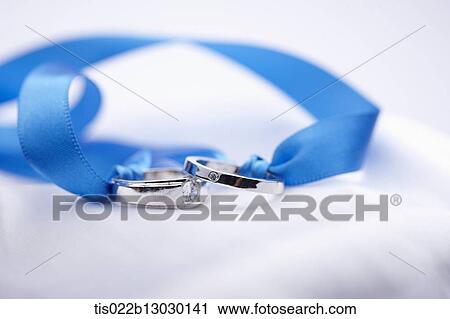 Clip Art - wedding rings in a blue ribbon. Fotosearch