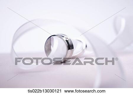 Clip Art - wedding rings in a white ribbon. Fotosearch